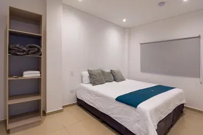 a bedroom with a bed and a large screen at Amazing Beach House 13BR w/Pool & Staff in Cartagena de Indias