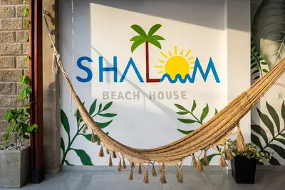 a sign for a beach house with a hammock at Amazing Beach House 13BR w/Pool & Staff in Cartagena de Indias