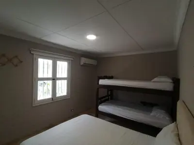 a bedroom with two bunk beds and a window at Capitel Hostel in Cartagena de Indias