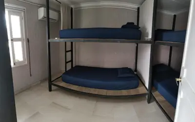 two bunk beds in a room with a window at Capitel Hostel in Cartagena de Indias