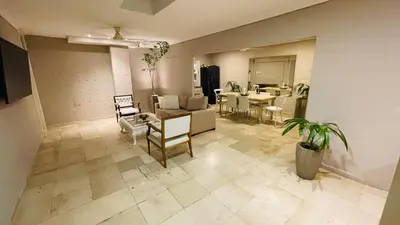 a living room with a couch and a table at Capitel Hostel in Cartagena de Indias