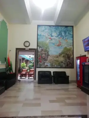 a living room with a large painting on the wall at Hotel Colonial Inn in Barranquilla