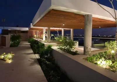 a building with a pathway in front of it with lights at Apartamento en edificio con espectacular terraza in Cartagena de Indias