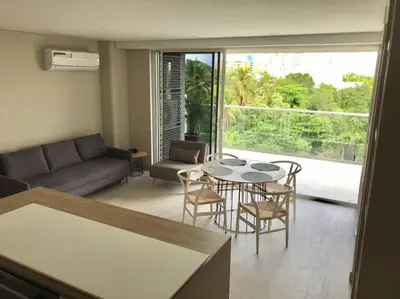 a living room with a table and chairs and a couch at Apartamento en edificio con espectacular terraza in Cartagena de Indias