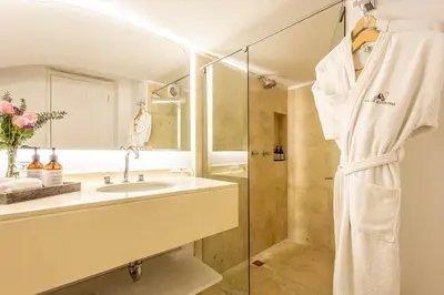 a bathroom with a sink and a shower at Hotel Casa del Gobernador in Cartagena de Indias