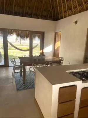 a kitchen with a table and a dining room with a table at Casita del Viento in San Bernardo del Viento