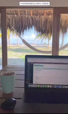 a laptop computer sitting on a table with a cup of coffee at Casita del Viento in San Bernardo del Viento
