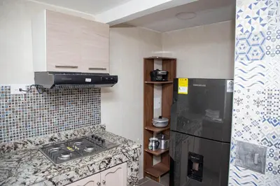 a kitchen with a black refrigerator and a sink at CASA PETRA in Cartagena de Indias