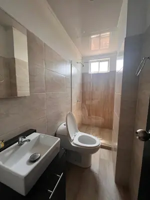 a bathroom with a white toilet and a sink at Hotel Paranawa in Baranoa