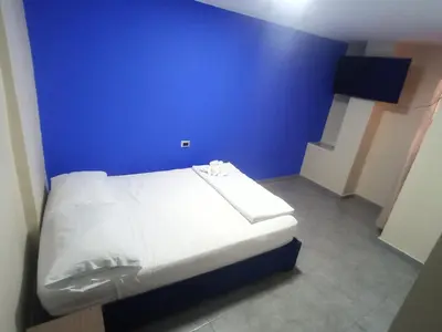 a blue bedroom with a bed in a room at CASA HOTEL YEMI in Barranquilla