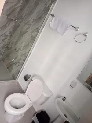 a bathroom with a toilet and a shower at CASA HOTEL YEMI in Barranquilla
