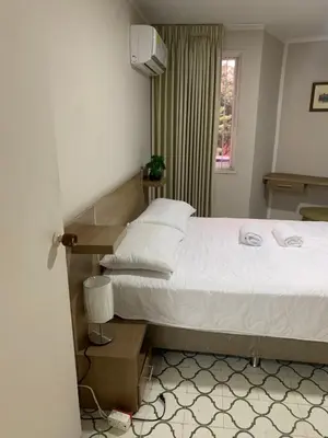a bedroom with a large bed and a window at Apartahotel Edificio Baquero x5 Apto 301 in Barranquilla