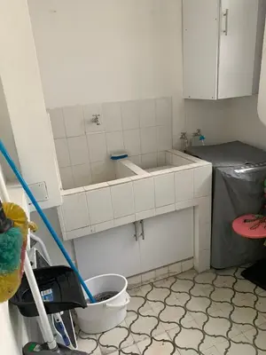 a white kitchen with a sink and a toilet at Apartahotel Edificio Baquero x5 Apto 201 in Barranquilla