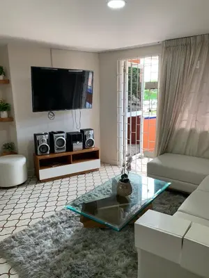 a living room with a couch and a tv at Apartahotel Edificio Baquero x5 Apto 201 in Barranquilla