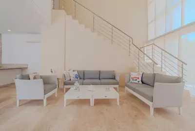 a living room with two couches and a coffee table at Exclusiva casa en Baru con piscina y playa privada in Playa Blanca