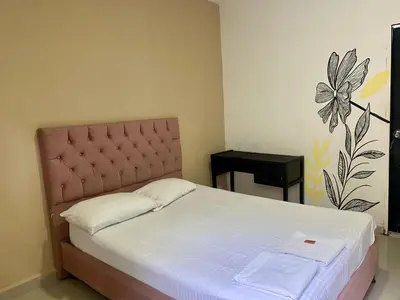 a bedroom with a bed and a side table at HOTEL SANTA MONICA in Barranquilla