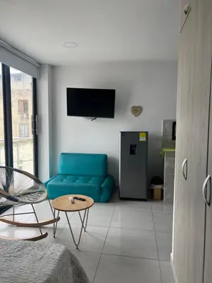 a living room with a blue couch and a table at Edificio Buenos Aires apartamento 304 moderno Sincelejo in Sincelejo