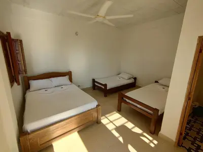 a bedroom with two beds and a ceiling at La Casa del Mar - Hotel Familiar en San Bernardo del Viento in San Bernardo del Viento