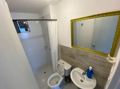 a bathroom with a toilet and a sink and a mirror at Nice apartment close to the Marbella beach in Cartagena de Indias