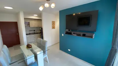 a dining room with a table and a blue wall at Nice apartment close to the Marbella beach in Cartagena de Indias