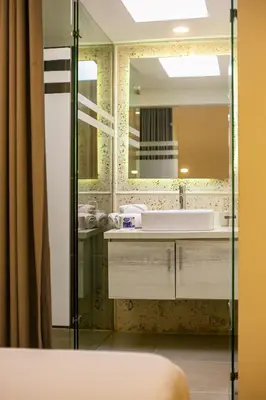 a bathroom with a sink and a mirror at Cartagena Suites de Manga in Cartagena de Indias