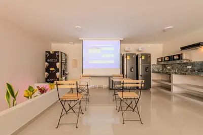 a class room with tables and chairs and a screen at Hostel Dorado Plaza Getsemaní in Cartagena de Indias