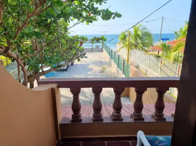 a balcony with a view of the beach at Cabaña Lilimar. in La Perdiz