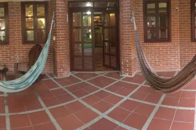 two hammocks hanging from the side of a brick building at Casa de playa Nijegi en Santa Veronica in Juan de Acosta