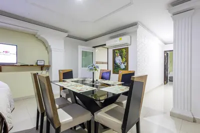 a dining room with a glass table and chairs at APARTAMENTO CATALINA BOCAGRANDE 1b in Cartagena de Indias
