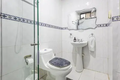 a bathroom with a toilet and a sink and a shower at APARTAMENTO CATALINA BOCAGRANDE 1b in Cartagena de Indias