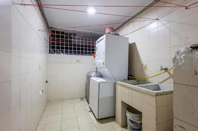 a small kitchen with a refrigerator and a sink at APARTAMENTO CATALINA BOCAGRANDE 1b in Cartagena de Indias