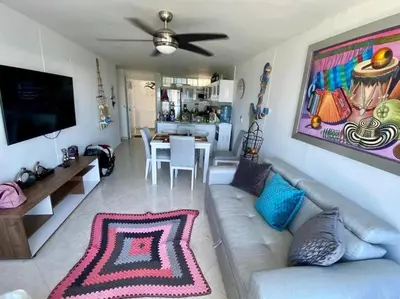 a living room with a couch and a dining room at Perla Santa - Luxury Condo in Santa Marta