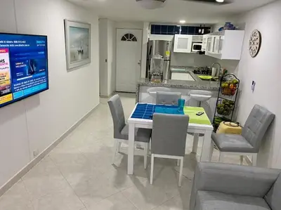 a kitchen and dining room with a table and chairs at Perla Santa - Luxury Condo in Santa Marta