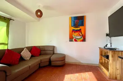 a living room with a couch and a flat screen tv at Gorgeous 8 BR House w/ Pool in the Old City in Cartagena de Indias