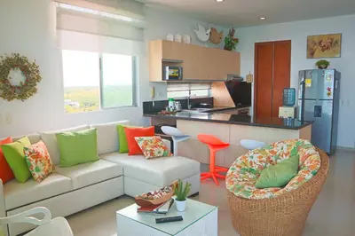 a living room with a couch and a kitchen at Magico Apartamento Frente al Mar 3 Habitaciones PV81 in Coveñas