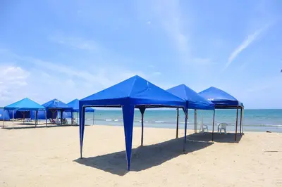 a group of blue tents on a beach at Magico Apartamento Frente al Mar 3 Habitaciones PV81 in Coveñas