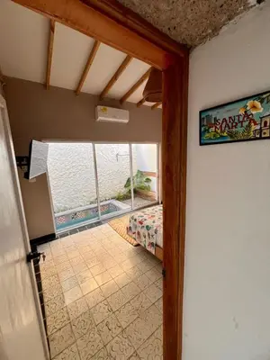 a view of a room with a bed and a window at Colonial Beach Airport Hotel in Cartagena de Indias
