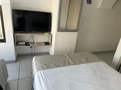 a room with a tv and a bed in a room at BARLOVENTO in Cartagena de Indias