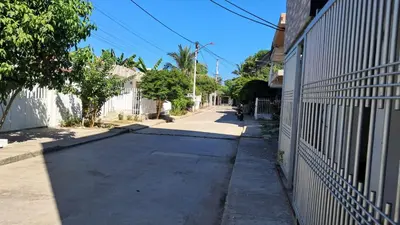 an empty street next to a house with a fence at Piantini Houses in Coveñas