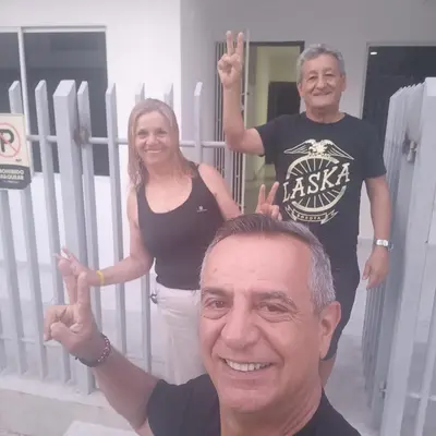 a man and two women standing in front of a fence at Piantini Houses in Coveñas