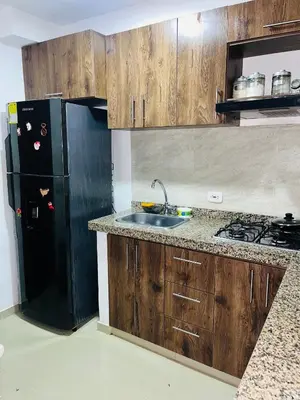 a kitchen with a black refrigerator and a sink at Habitación Disponible en Cartagena cerca a la terminal de transporte in Cartagena de Indias