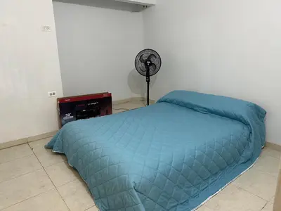 a bedroom with a blue bed and a fan at Casa Tamarielys 3 Habitaciones in Cartagena de Indias
