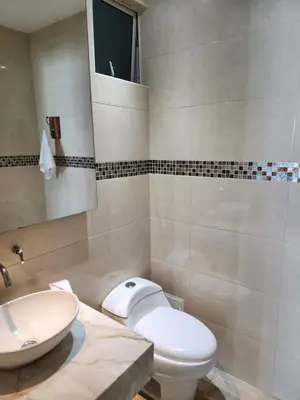 a bathroom with a white toilet and a sink at Apartamento con terraza Frente al Mar in Cartagena de Indias