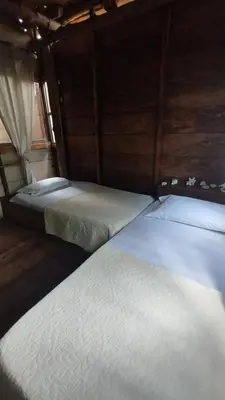 two twin beds in a room with a window at Mi Cabañita Guest House in Playa Blanca