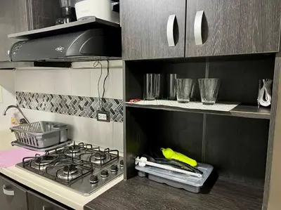 a kitchen with a stove top oven in a kitchen at Tu lugar ideal cerca al mar apartamento MyM in Coveñas