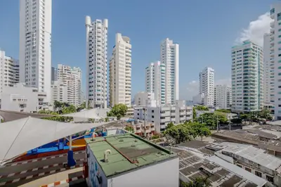 a tennis court on top of a building in a city at Amplia habitación con vista al mar y baño privado in Cartagena de Indias