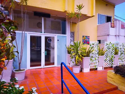 a patio with potted plants in front of a building at Hotel Casa Boston Inn by Finerh in Barranquilla