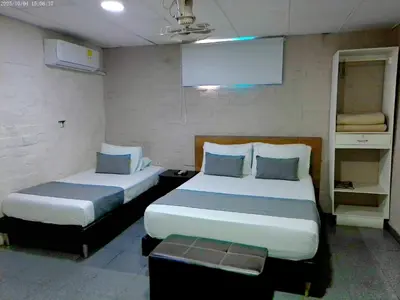 two beds in a small room with two beds sidx sidx sidx at Hotel Casa Boston Inn by Finerh in Barranquilla