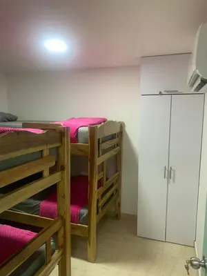 two bunk beds in a room with pink sheets at Apartamento en la Boquilla in Cartagena de Indias