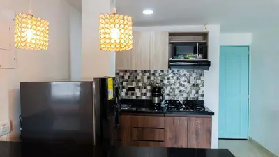 a kitchen with a stainless steel refrigerator and two lights at Apartamento en la Boquilla in Cartagena de Indias